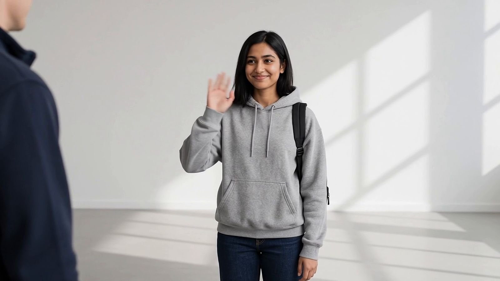 Team member in a navy jacket greeting a student at arrivals (illustrative image)